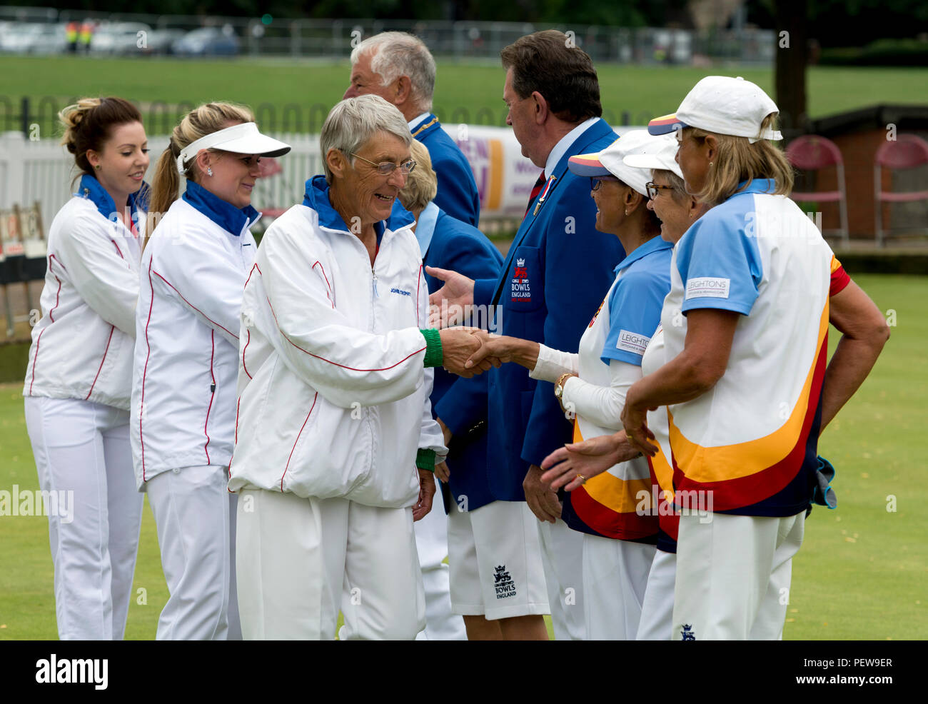 Players and umpires shaking hands before the triples final at the